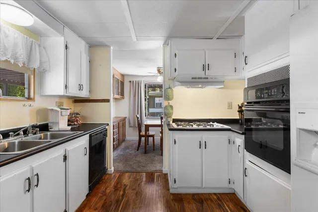 a kitchen with sink cabinets and wooden floor