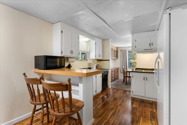 a view of a dining room with furniture and a kitchen