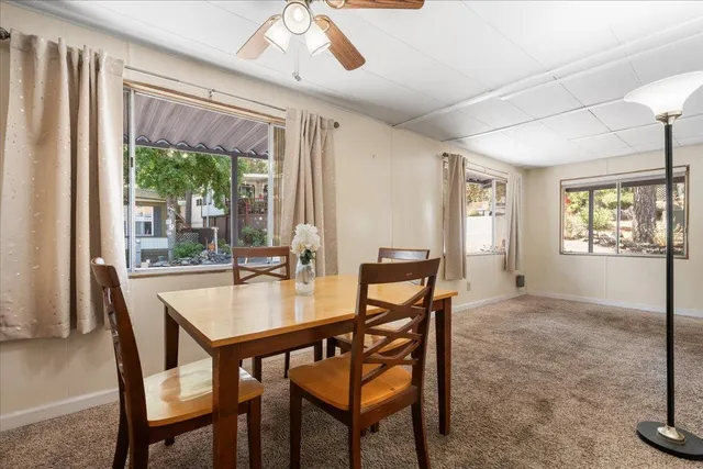 a dining room with furniture a chandelier and window