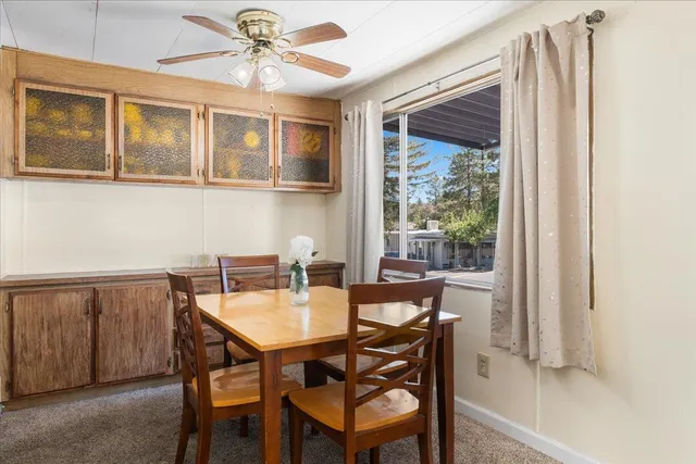 a living room with furniture and a dining table with kitchen view