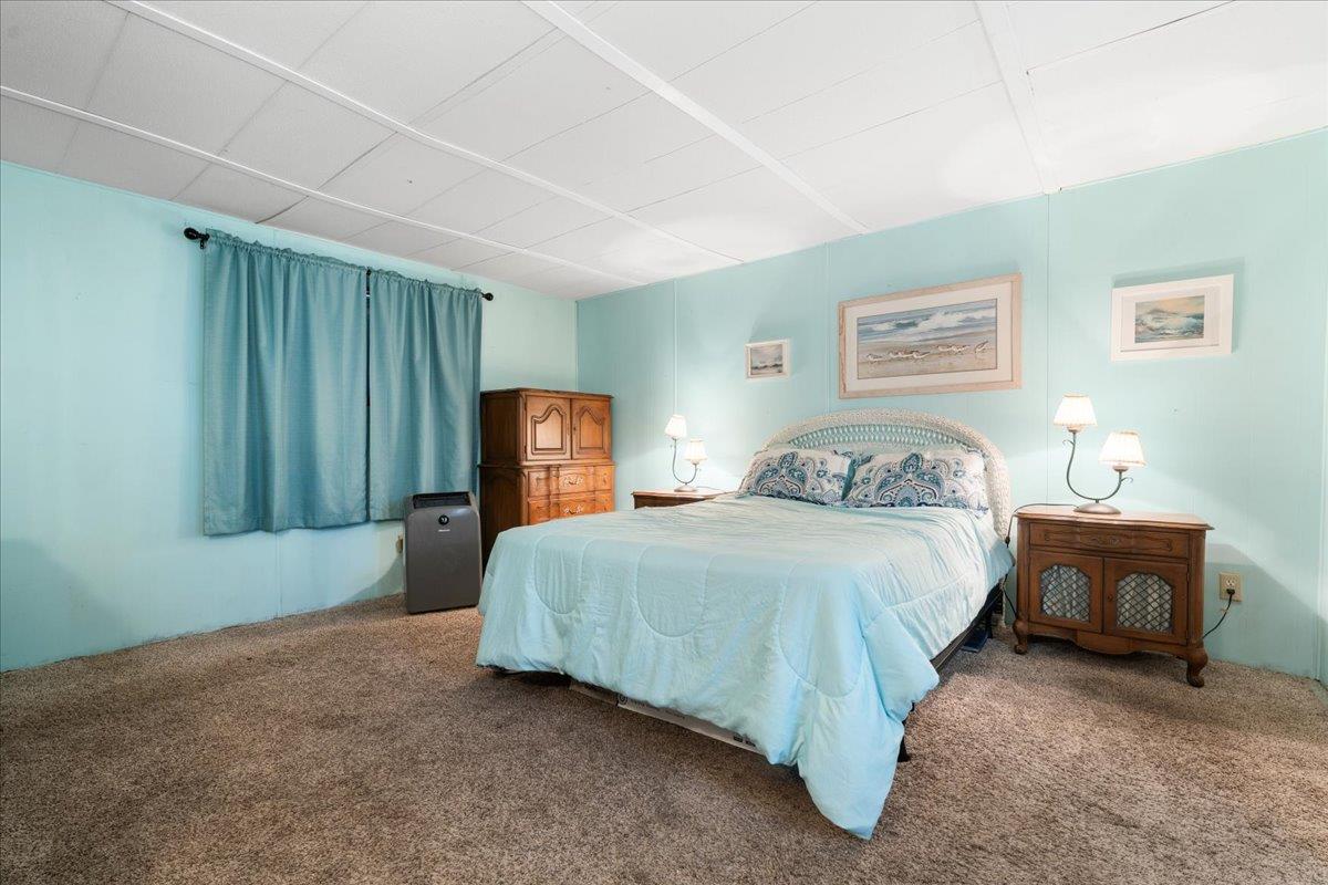 970 Laurel Lane Grass Valley, CA 95945 - Photo 32 of 44 a spacious bedroom with a bed and a lamp