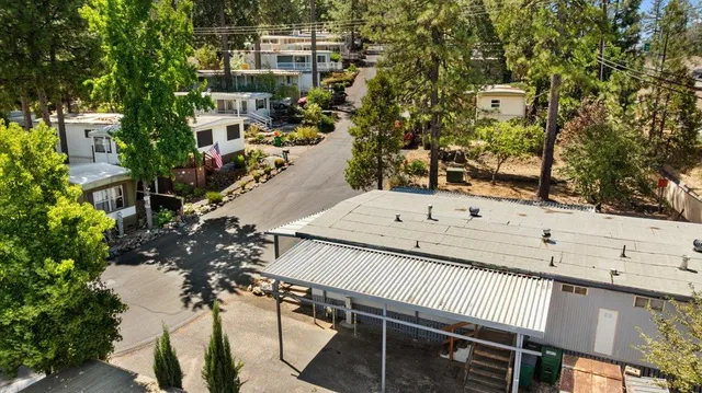 an aerial view of a residential houses with yard