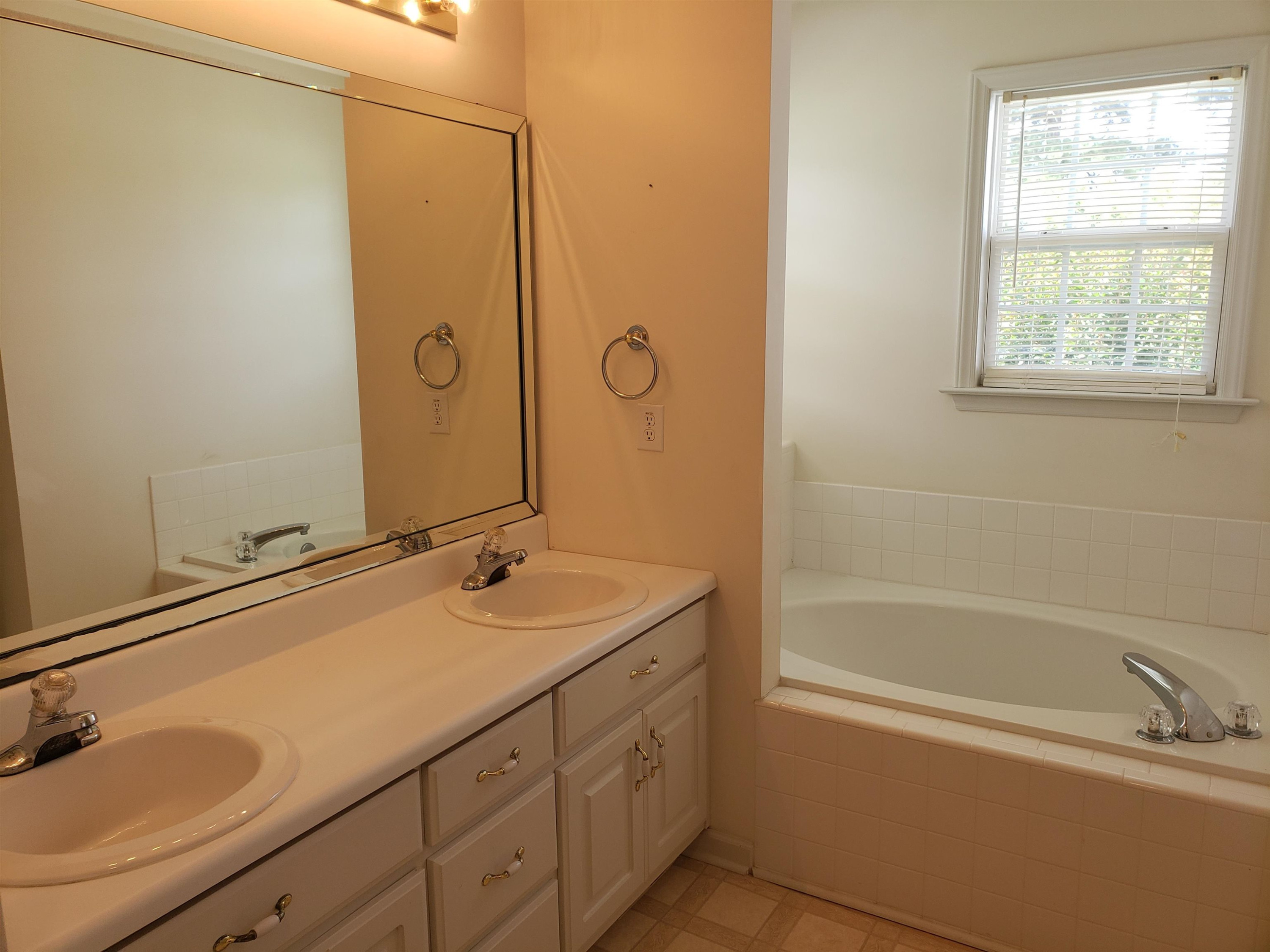 340 Parrish Memorial Road Selma, NC 27576 - Photo 12 of 17 a bathroom with a tub sink and mirror