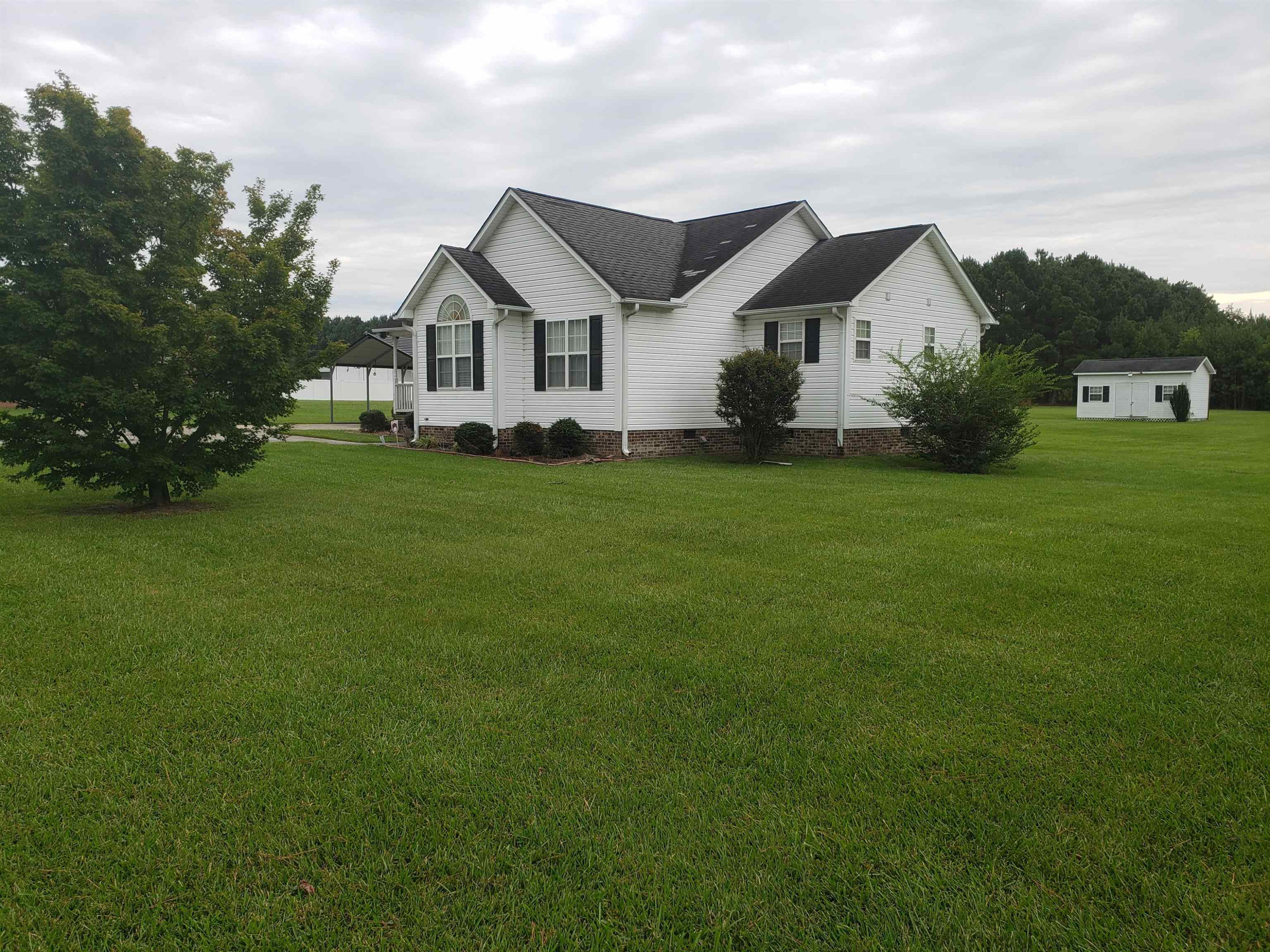 340 Parrish Memorial Road Selma, NC 27576 - Photo 16 of 17 a front view of a house with a garden