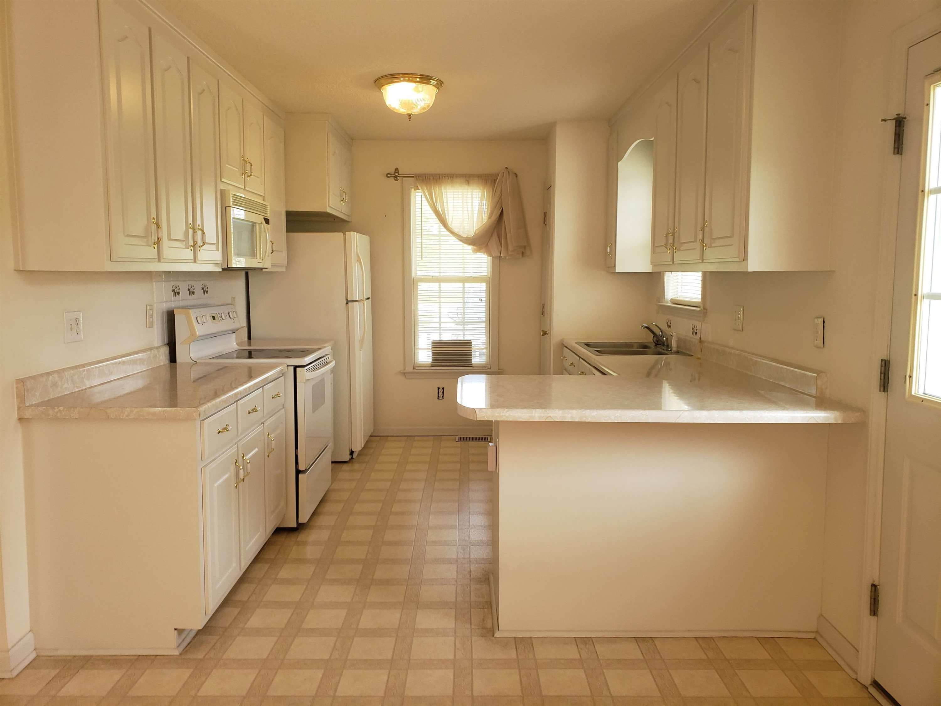 340 Parrish Memorial Road Selma, NC 27576 - Photo 6 of 17 a kitchen with a sink stove and cabinets