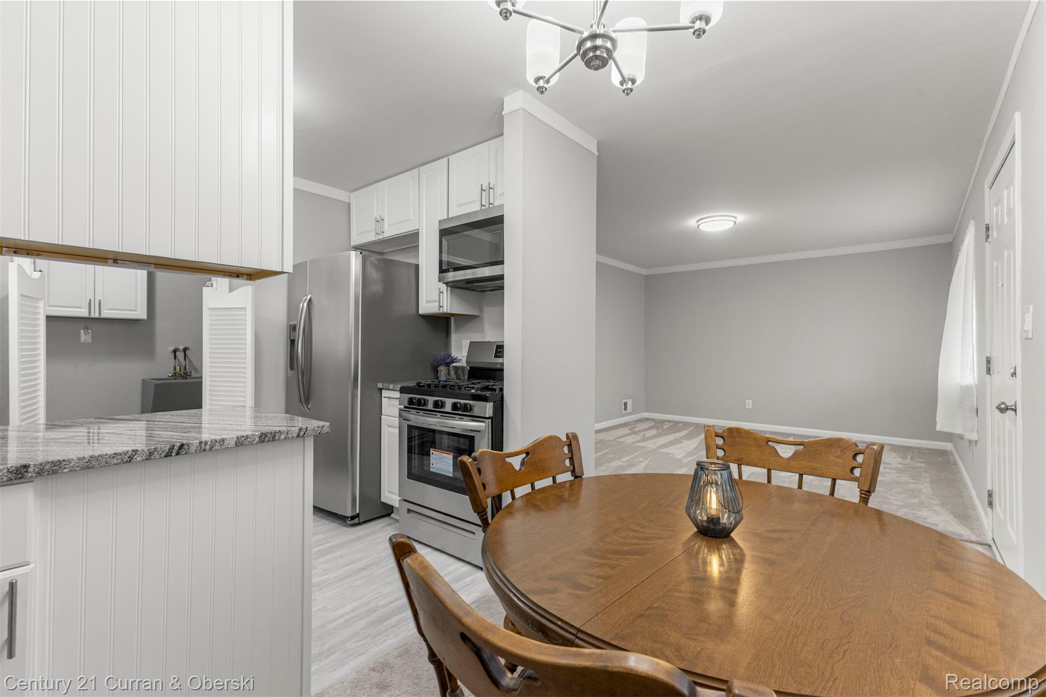 7120 Jackson Street Taylor, MI 48180 - Photo 15 of 24 Dining space with a chandelier, ornamental molding, and light wood finished floors