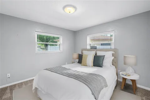 a bedroom with a bed and a lamp