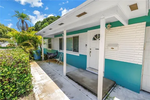 an aerial view of residential houses with city view
