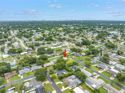an aerial view of residential houses with outdoor space and street view