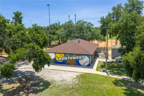 an aerial view of a houses with a swimming pool