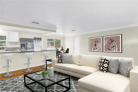 a living room with furniture and kitchen view