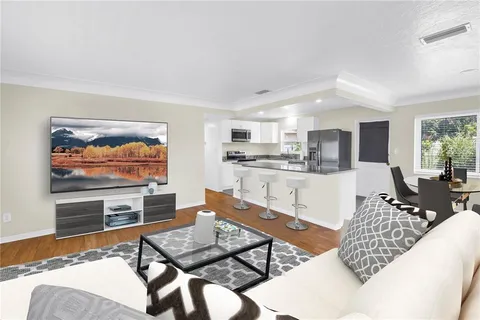 a living room with furniture and a flat screen tv