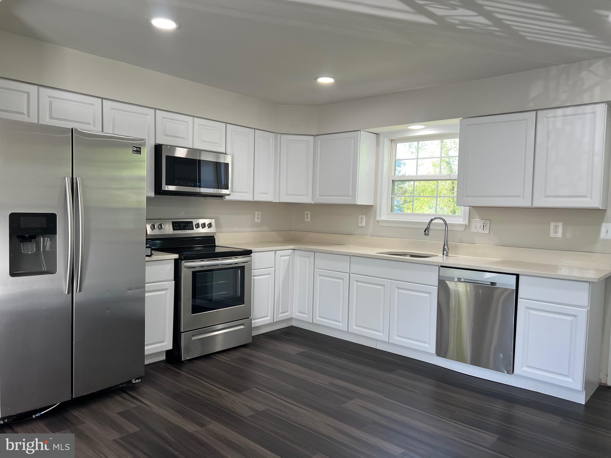6604 Suitland Road Suitland, MD 20746 - Photo 19 of 27 a kitchen with stainless steel appliances a refrigerator sink and microwave