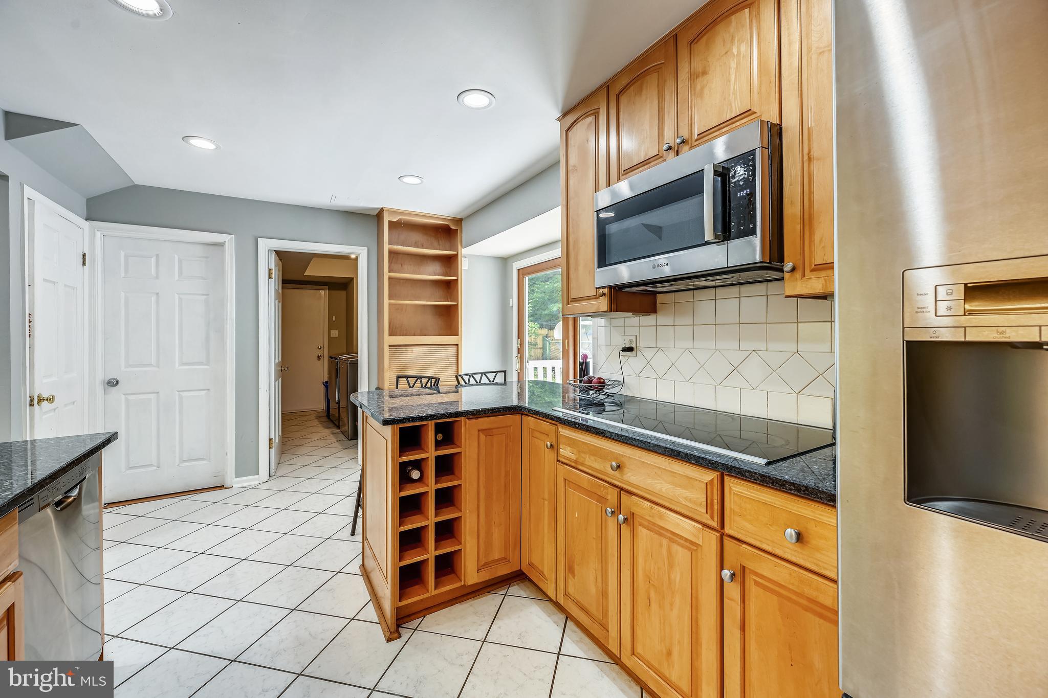 2116 Kings House Road Silver Spring, MD 20905 - Photo 20 of 37 a kitchen with stainless steel appliances granite countertop a sink and a microwave