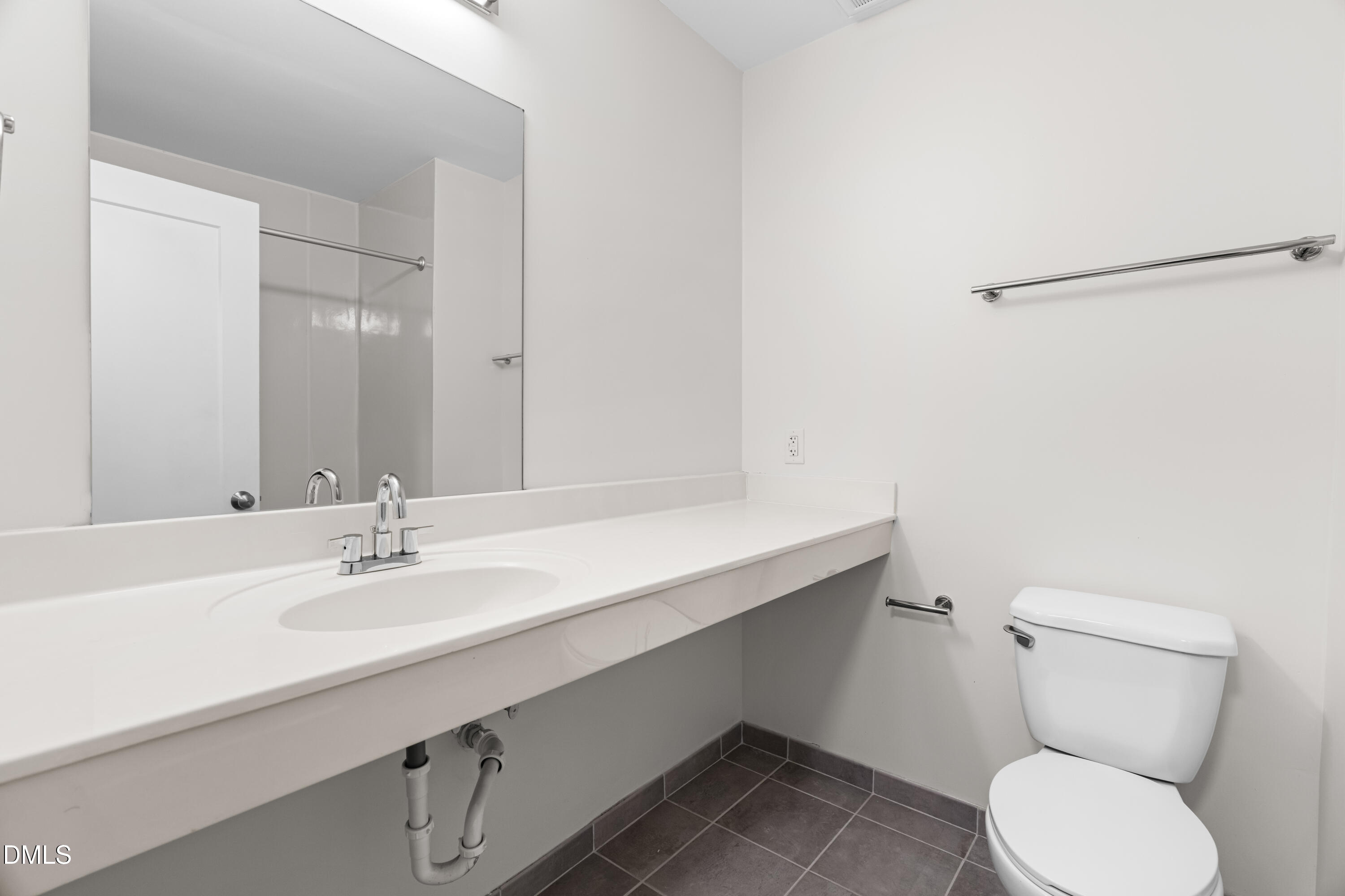 5104 Hollyridge Drive, Unit 303 Raleigh, NC 27612 - Photo 11 of 21 a bathroom with a sink toilet and vanity