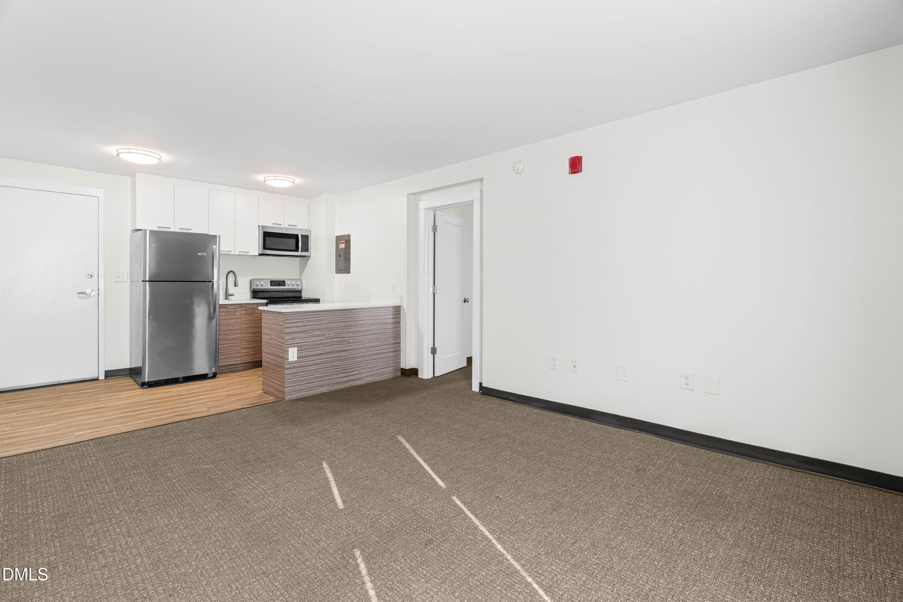 5104 Hollyridge Drive, Unit 303 Raleigh, NC 27612 - Photo 15 of 21 a view of an empty room with a kitchen