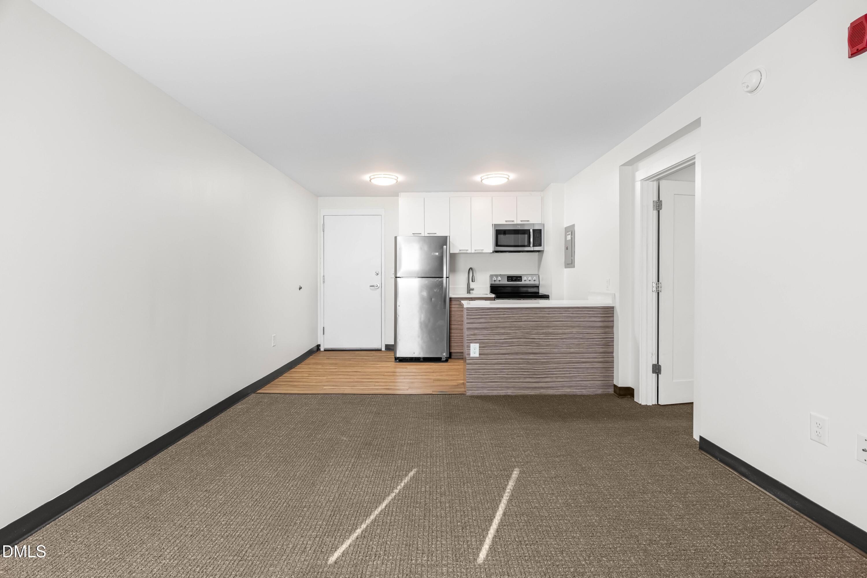 5104 Hollyridge Drive, Unit 303 Raleigh, NC 27612 - Photo 16 of 21 a view of a kitchen with refrigerator and microwave