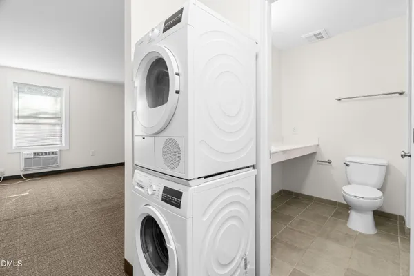 a view of a storage and utility room with washer and dryer