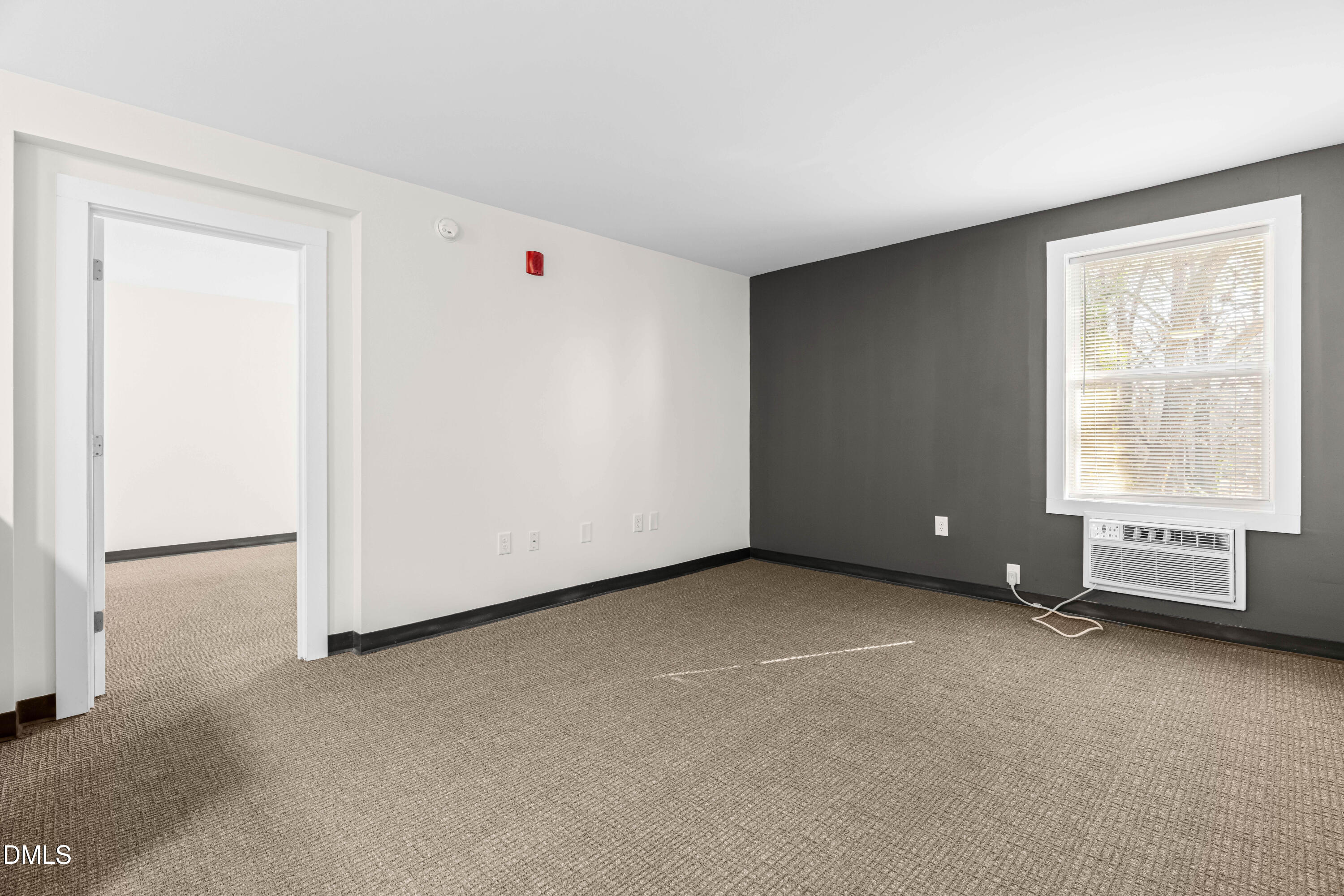 5104 Hollyridge Drive, Unit 303 Raleigh, NC 27612 - Photo 4 of 21 a view of an empty room with a window