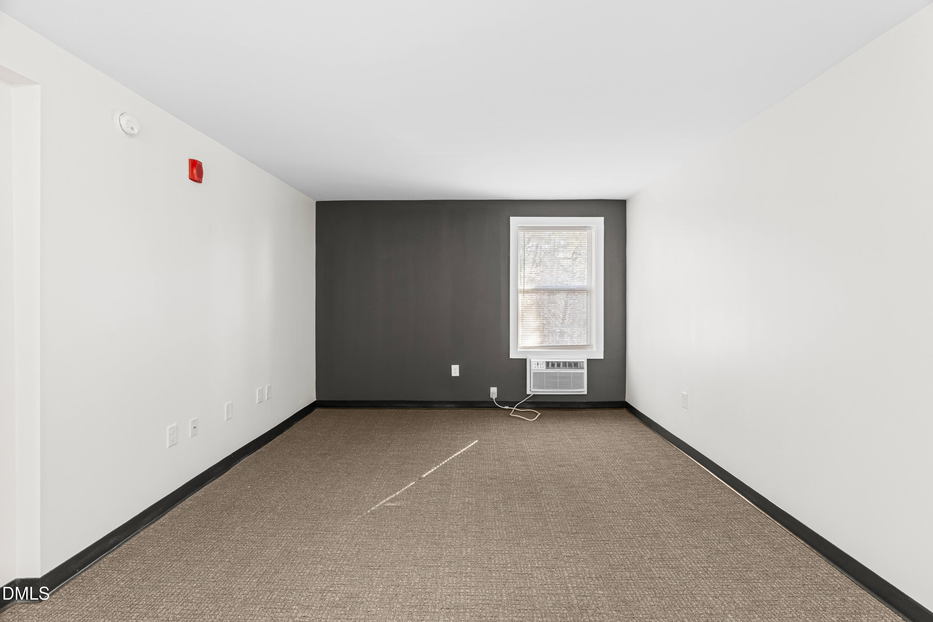 5104 Hollyridge Drive, Unit 303 Raleigh, NC 27612 - Photo 9 of 21 an empty room with windows