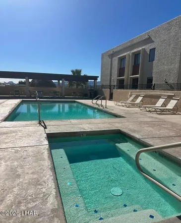 swimming pool view with a seating space