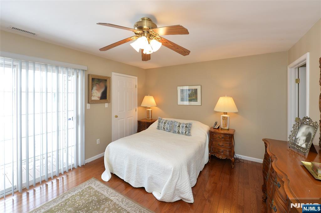 40 Chanda Court, Unit D040 Clifton, NJ 07012 - Photo 12 of 17 a bedroom with a bed and a chandelier
