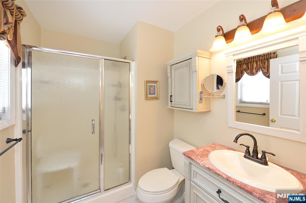40 Chanda Court, Unit D040 Clifton, NJ 07012 - Photo 14 of 17 a bathroom with a sink toilet and shower