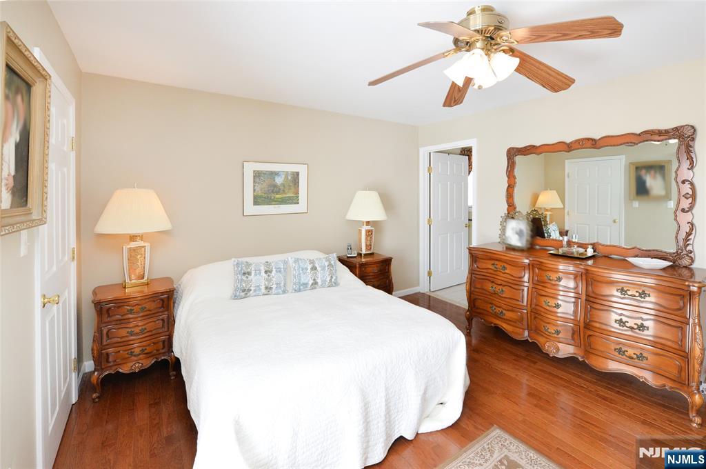 40 Chanda Court, Unit D040 Clifton, NJ 07012 - Photo 16 of 17 a bedroom with a bed and a chandelier