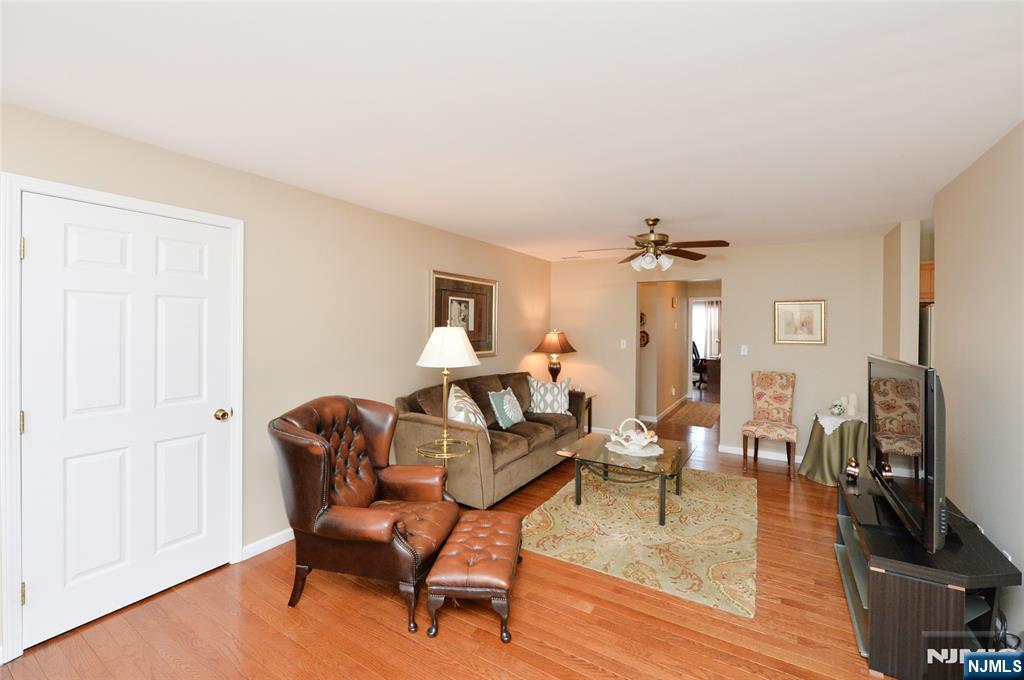 40 Chanda Court, Unit D040 Clifton, NJ 07012 - Photo 5 of 17 a living room with furniture and a wooden floor