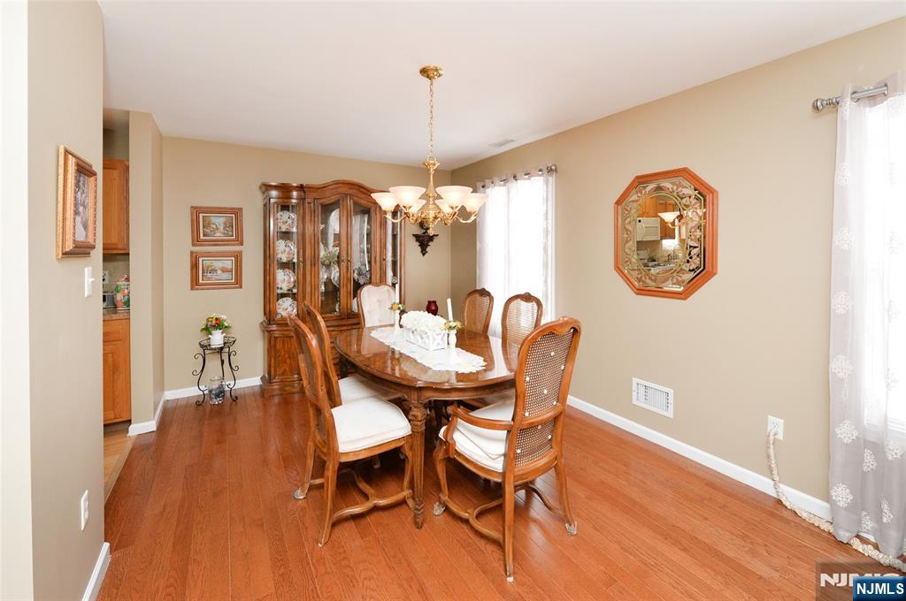 40 Chanda Court, Unit D040 Clifton, NJ 07012 - Photo 6 of 17 a view of a dining room with furniture and chandelier
