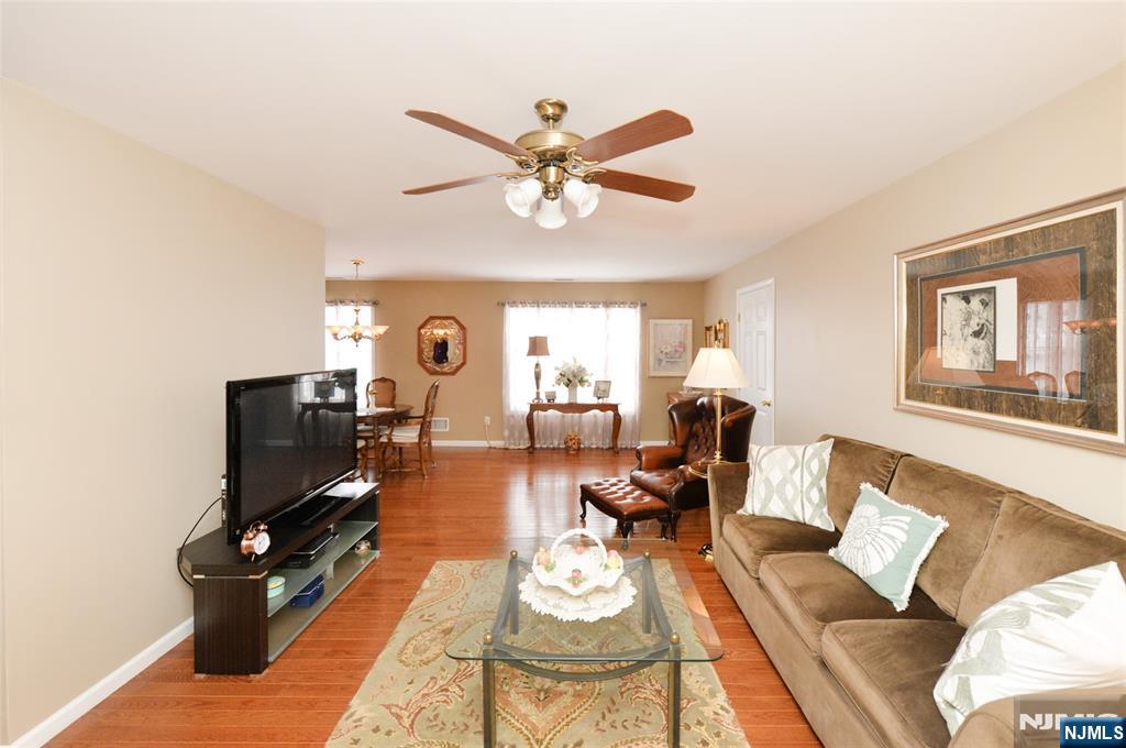 40 Chanda Court, Unit D040 Clifton, NJ 07012 - Photo 7 of 17 a living room with furniture and a flat screen tv