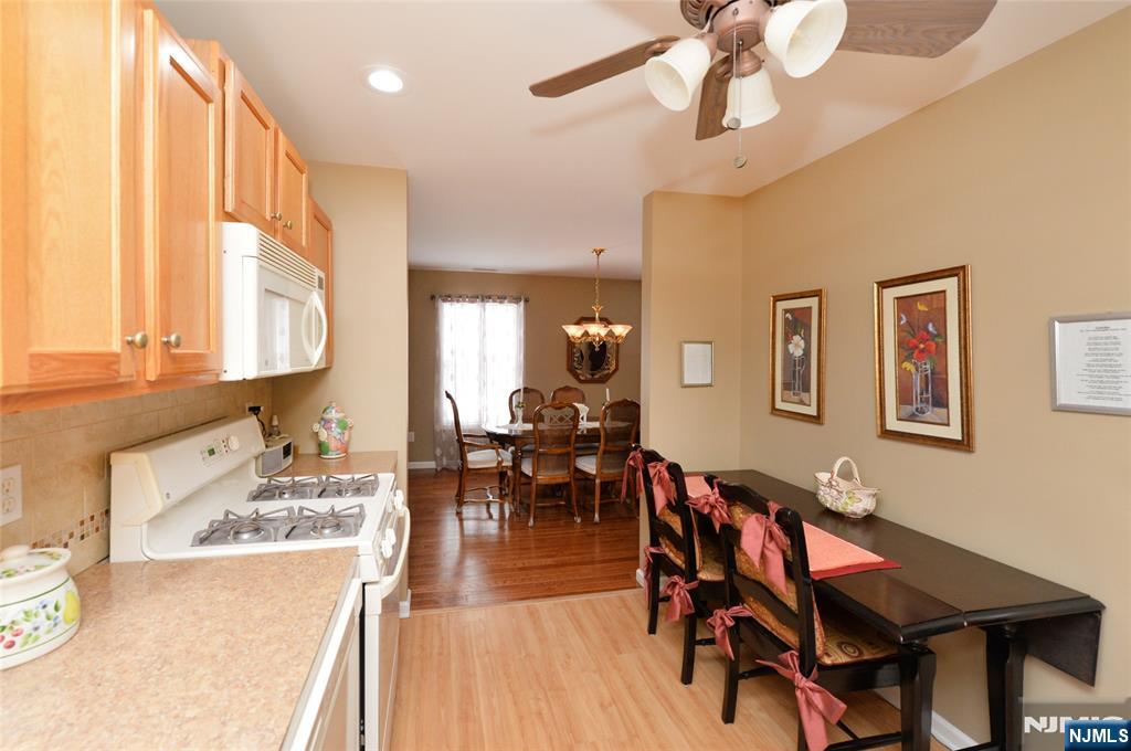 40 Chanda Court, Unit D040 Clifton, NJ 07012 - Photo 10 of 17 a living room with dining room and wooden floor