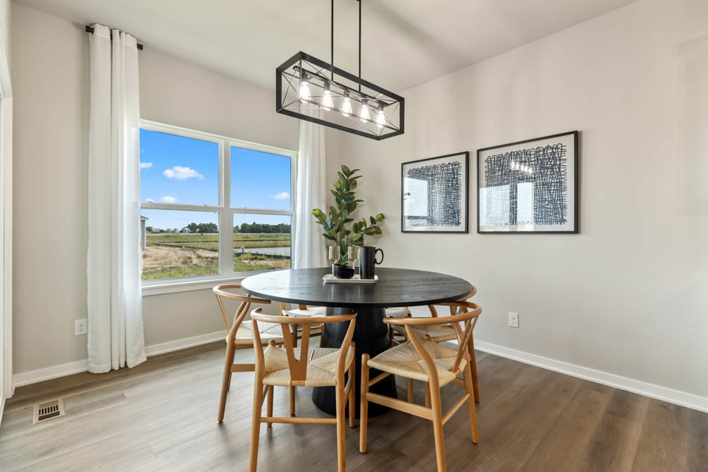 315 Snowdrop Lane Elgin, IL 60124 - Photo 11 of 46 a view of a dining room with furniture a chandelier and wooden floor