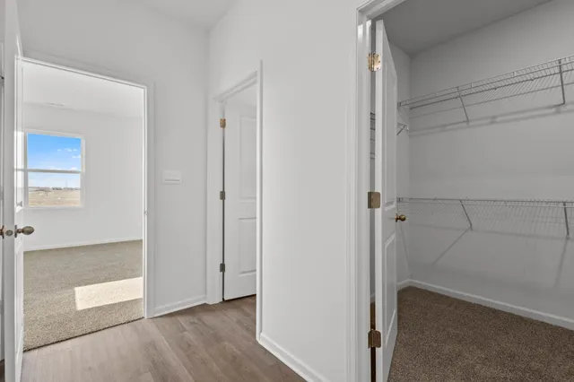 a bathroom view of a toilet and a hardwood