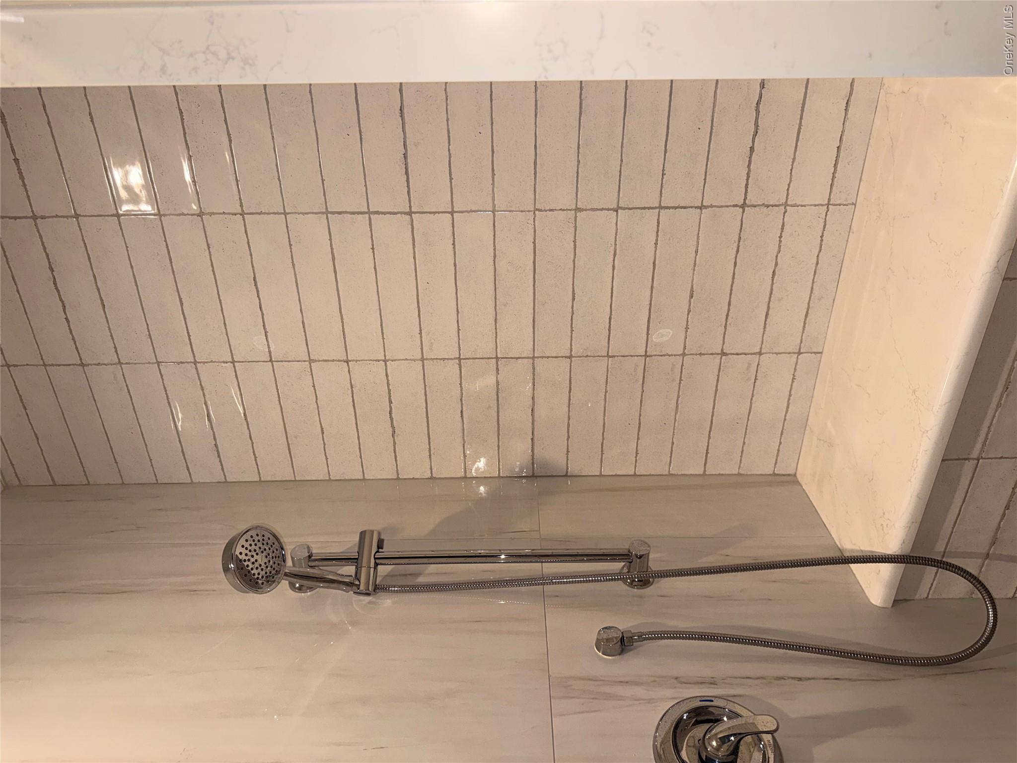 1661 Old Country Road, Unit 516 Riverhead, NY 11901 - Photo 46 of 50 a bathroom with a shower