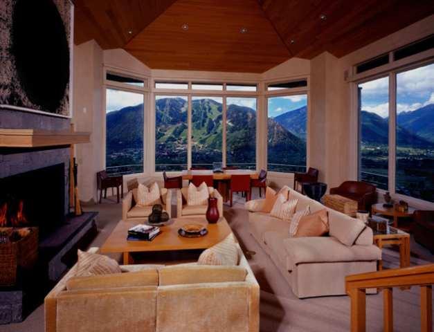 a living room with furniture a large window and a fireplace
