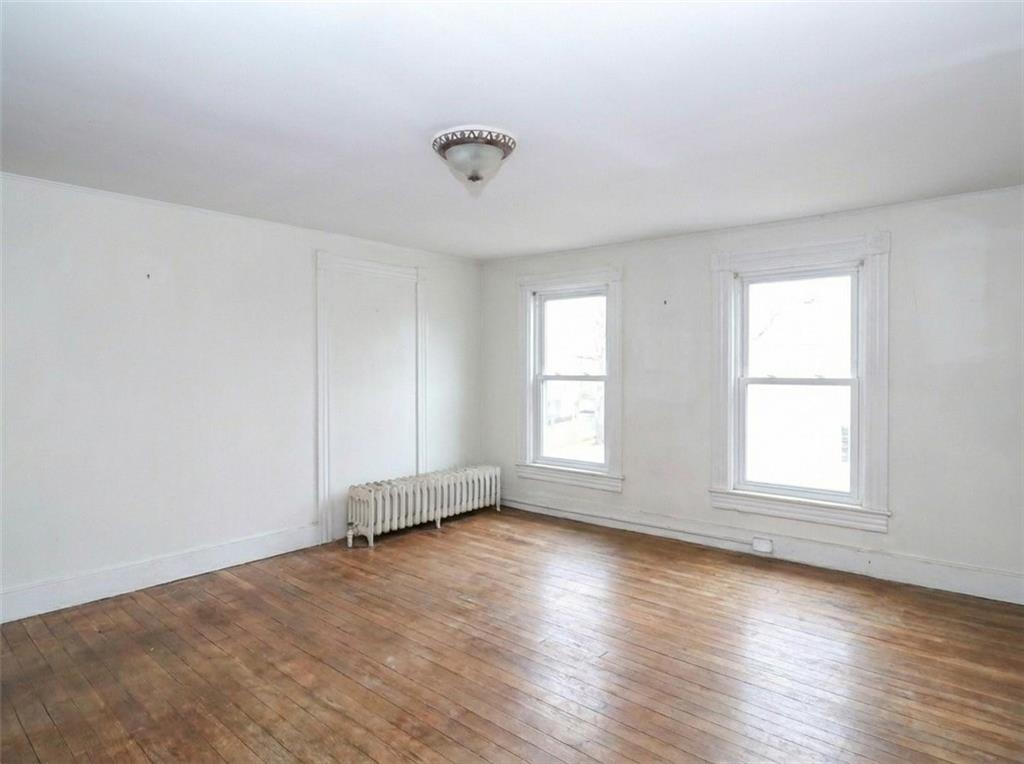 636 Holmdel Road Hazlet, NJ 07730 - Photo 24 of 47 an empty room with wooden floor and windows