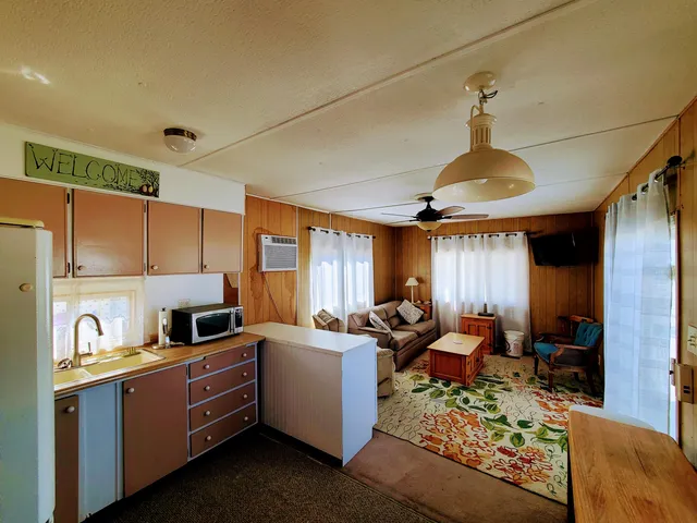 a kitchen with stainless steel appliances granite countertop a sink counter space cabinets and a window