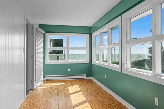 a view of a big room with a ceiling fan and a window