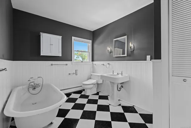 an empty room with fan and windows