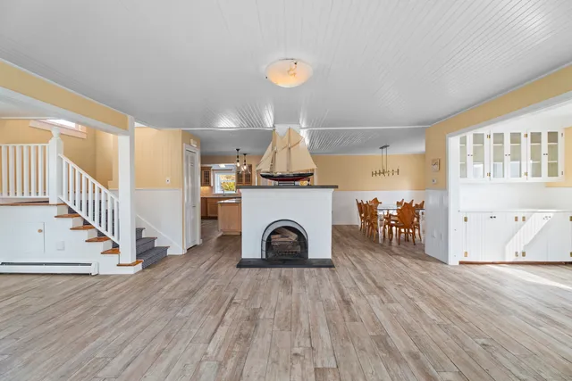 a view of a livingroom with wooden floor and staircase