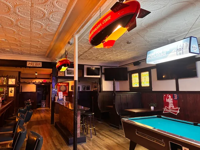 an outdoor living room with furniture and fireplace