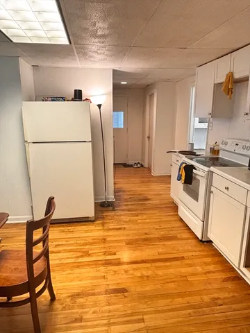 a view of a kitchen with a sink dishwasher and a refrigerator