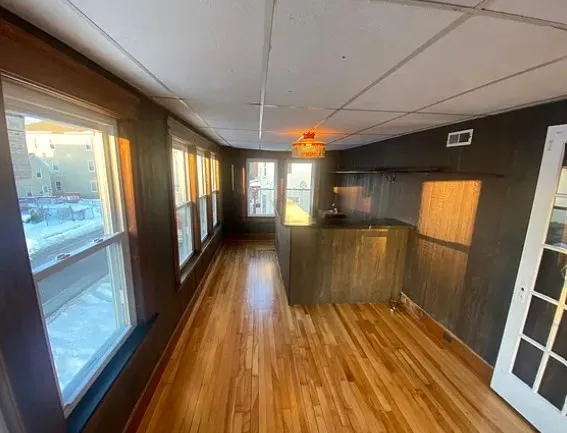 a view of a room with wooden floor