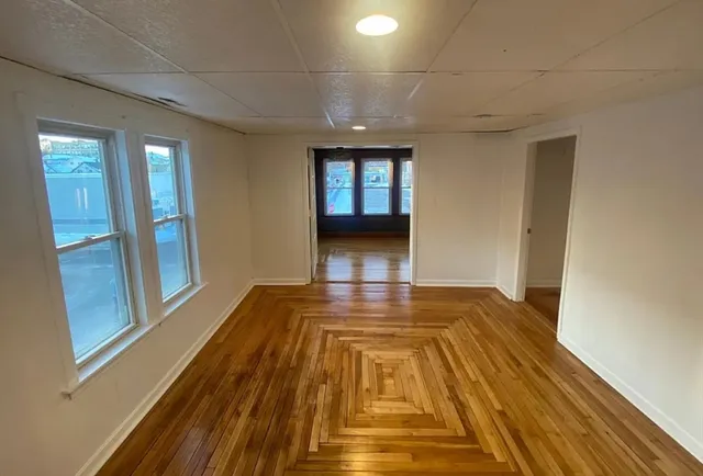 a view of a room with wooden floor and staircase