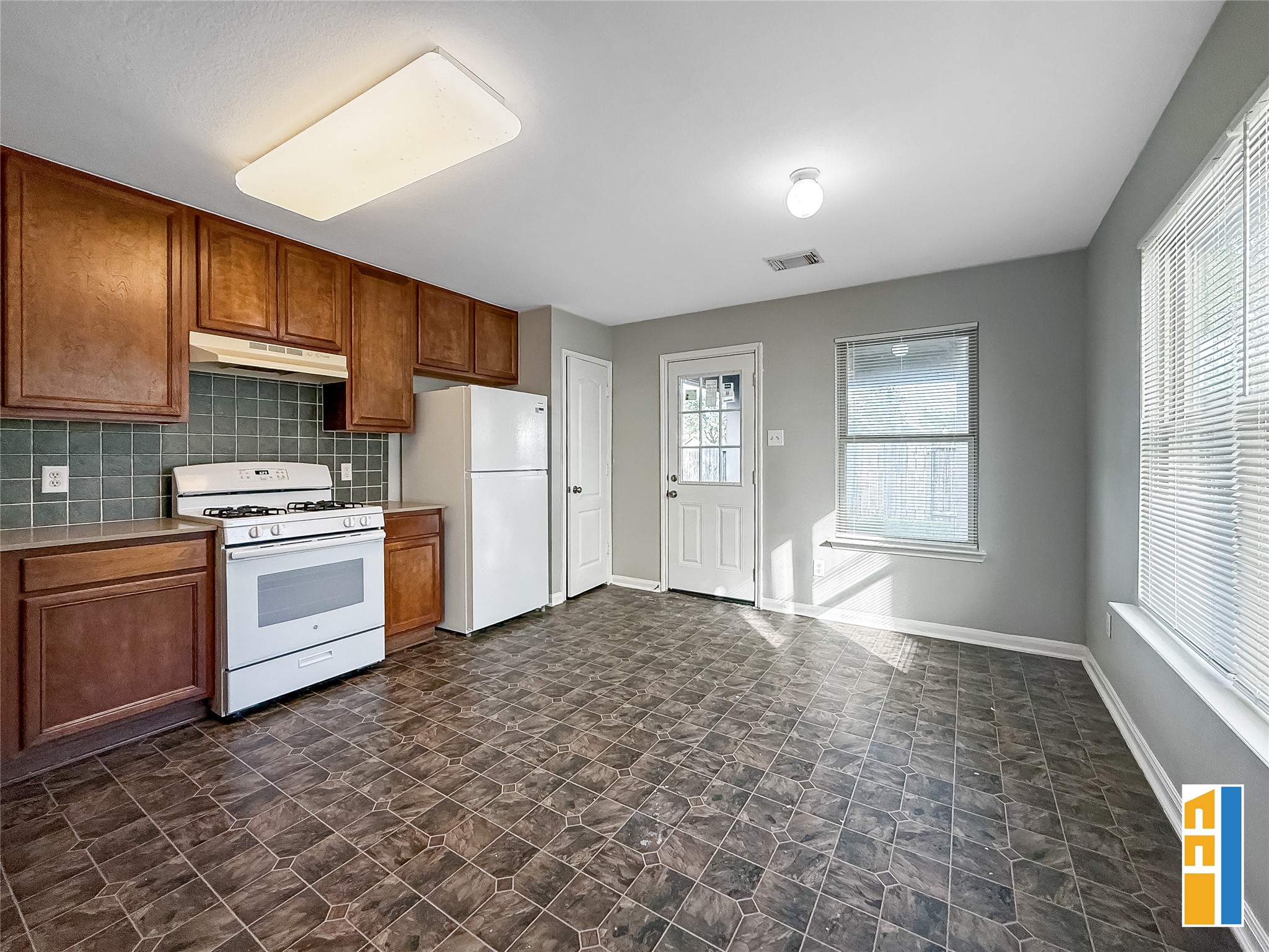 29566 North Legends Bend Drive Spring, TX 77386 - Photo 12 of 21 Discover a bright and inviting kitchen boasting rich wood cabinetry, sleek appliances, and an abundance of natural light, perfect for creating culinary delights.