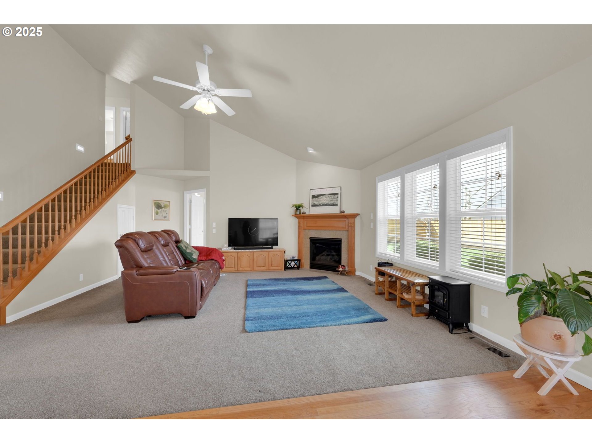 832 Mint Meadow Way Springfield, OR 97477 - Photo 6 of 31 a living room with furniture a fireplace and a flat screen tv