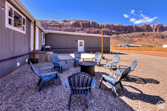 33 Merriam Court Moab, UT 84532 - Photo 50 of 56 Back patio and firepit. View of separate basement entrance and parking (3 spaces)