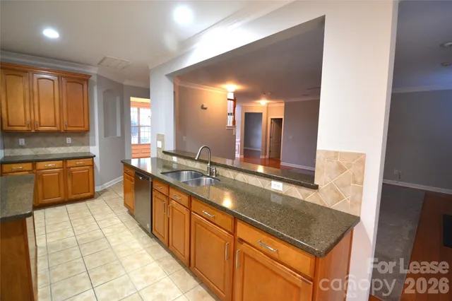a large kitchen with kitchen island granite countertop a sink and a stove