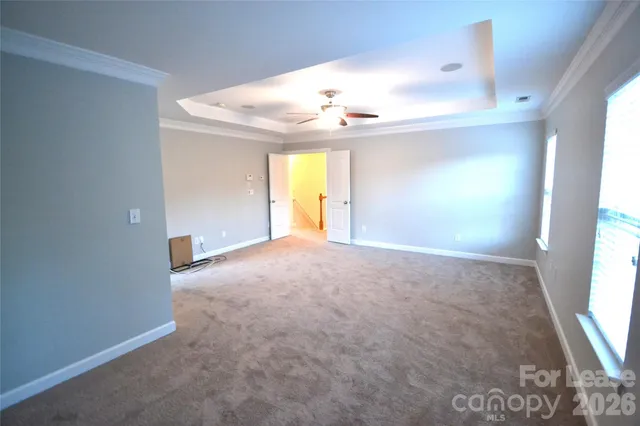 an empty room with windows and wooden floor